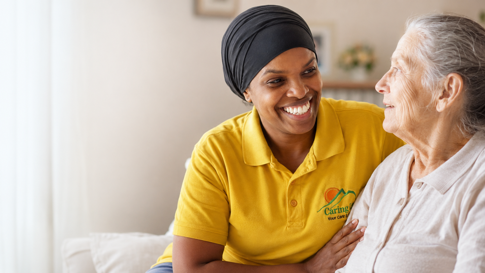 Safia Mohamed of Caring Lane speaking warmly with an older woman at home